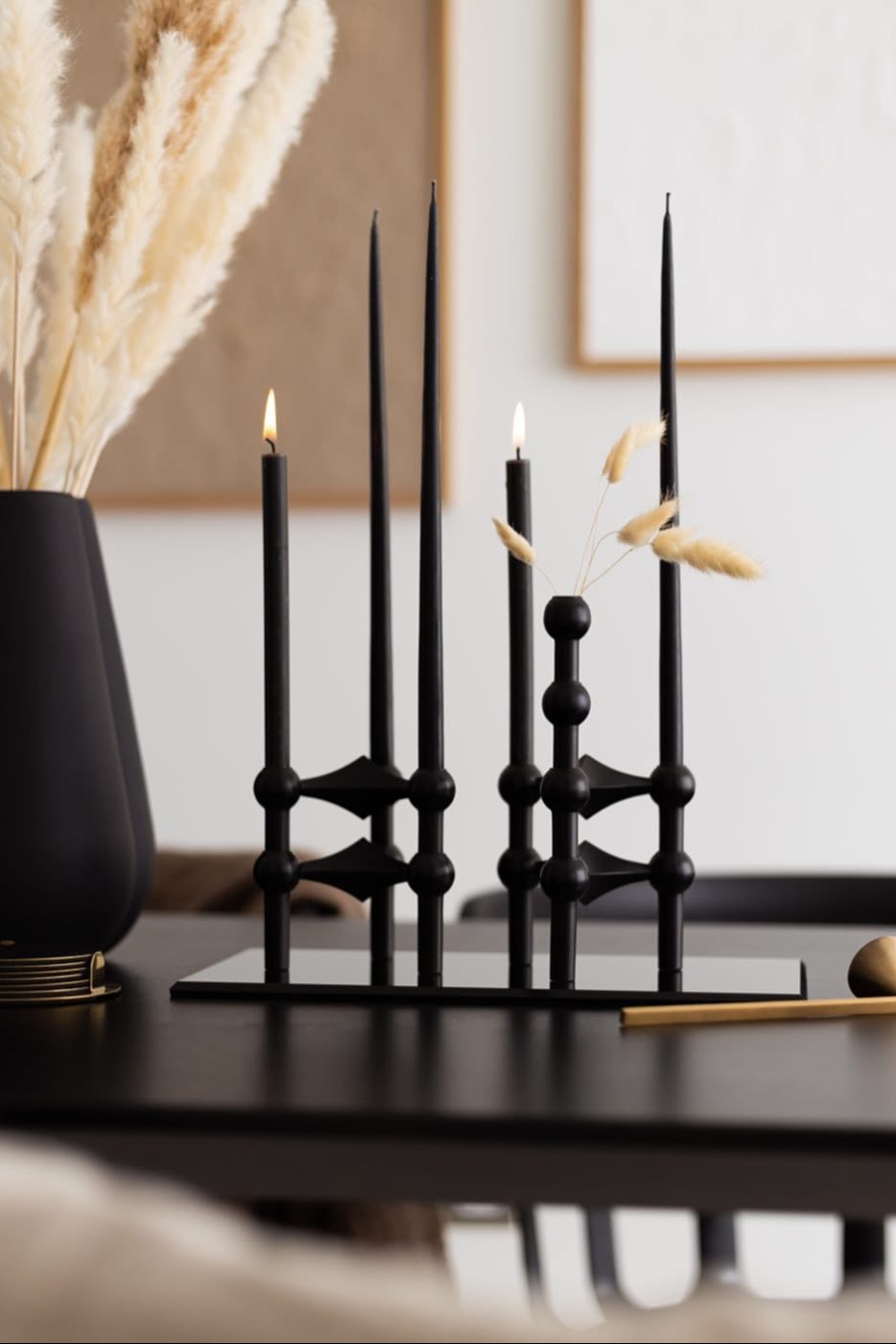 Boho y otros estilos de interiorismo: aquí puedes ver el portavelas de clavos negros de STOFF con velas negras, decorado por la usuaria de Instagram @bythun.